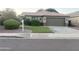 Single-Gathering home with a desert landscaped front yard, an attached garage, and green grass at 9212 W Salter Dr, Peoria, AZ 85382