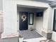Charming home entrance with a black front door with decorative wreath and welcome mat at 9212 W Salter Dr, Peoria, AZ 85382