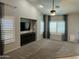 Spacious living room with vaulted ceilings, large windows with shutters, and a ceiling fan at 9212 W Salter Dr, Peoria, AZ 85382