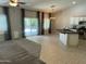 Open concept living space with tile and carpet floors and sliding glass doors to the backyard at 9212 W Salter Dr, Peoria, AZ 85382