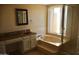Relaxing bathroom featuring a large soaking tub, separate sink, and natural light at 10326 W Harmont Dr, Peoria, AZ 85345
