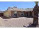 The front of the house, with gravel landscaping and a brick facade, complemented by a mature palm tree at 10326 W Harmont Dr, Peoria, AZ 85345