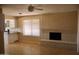 Open living area with brick fireplace, tile floors and white cabinets, perfect for entertaining at 10326 W Harmont Dr, Peoria, AZ 85345