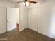 Bedroom features ceiling fan, carpeted floors, and a closet with sliding doors at 1048 E 6Th Ave, Mesa, AZ 85204