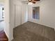 Bright bedroom featuring neutral carpet, ceiling fan, and closet with folding doors at 1048 E 6Th Ave, Mesa, AZ 85204