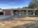 Charming single-story home featuring a covered porch, a garage and a spacious front yard at 1048 E 6Th Ave, Mesa, AZ 85204