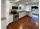 Updated kitchen with white cabinets, stainless steel appliances, and hardwood floors at 1048 E 6Th Ave, Mesa, AZ 85204
