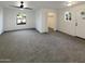 Spacious carpeted living room features a ceiling fan and multiple windows at 1048 E 6Th Ave, Mesa, AZ 85204