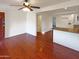 Open-concept living room showcasing wood floors and seamless flow into the kitchen at 1048 E 6Th Ave, Mesa, AZ 85204