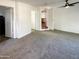 Spacious carpeted living room featuring white walls and multiple doorways at 1048 E 6Th Ave, Mesa, AZ 85204
