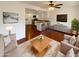 Open-concept living room featuring hardwood floors, neutral furniture, and an open kitchen layout at 1048 E 6Th Ave, Mesa, AZ 85204