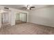 A spacious carpeted bedroom featuring sliding mirror closet doors and a ceiling fan at 1066 Leisure World --, Mesa, AZ 85206