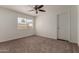 Bright bedroom with a large window, ceiling fan, and neutral carpeting at 1066 Leisure World --, Mesa, AZ 85206