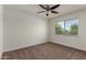 Bedroom features carpet, a ceiling fan, and a window with tree views at 1066 Leisure World --, Mesa, AZ 85206