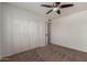 Cozy bedroom features plush carpeting, ceiling fan, and large closet with louvered doors at 1066 Leisure World --, Mesa, AZ 85206