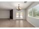 Open dining room features double doors to the yard, a modern chandelier, and tile flooring at 1066 Leisure World --, Mesa, AZ 85206