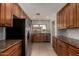 Updated kitchen features granite countertops, wood cabinets, stainless steel appliances, and tile flooring at 1066 Leisure World --, Mesa, AZ 85206