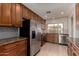 Well-lit kitchen featuring granite counters, wooden cabinets, stainless steel appliances, and ample counter space at 1066 Leisure World --, Mesa, AZ 85206