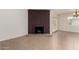 Bright living room featuring a red brick fireplace, tile floors, and views to the outside through french doors at 1066 Leisure World --, Mesa, AZ 85206
