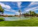 Scenic community pond with a fountain, surrounded by lush landscaping at 1066 Leisure World --, Mesa, AZ 85206