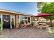Outdoor living space featuring an outdoor dining table, a patio and a beautifully decorated backyard at 1087 Leisure World --, Mesa, AZ 85206