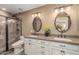 The bathroom features dual sinks, granite counters, and decorative framed mirrors at 1087 Leisure World --, Mesa, AZ 85206