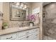 Bathroom features a vanity with granite counters, decorative tile backsplash, and a tiled shower at 1087 Leisure World --, Mesa, AZ 85206