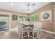 Inviting dining room features a chandelier, wood-look tile flooring, and views of the backyard at 1087 Leisure World --, Mesa, AZ 85206