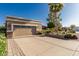 A clean, concrete driveway leading to the garage with brick-lined edges and desert landscaping on either side at 1087 Leisure World --, Mesa, AZ 85206