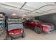 This garage offers ample space for vehicles and storage, with a golf cart and red SUV parked inside at 1087 Leisure World --, Mesa, AZ 85206