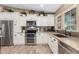Modern kitchen with stainless steel appliances, granite countertops, and wood-look floors for a warm, inviting space at 1087 Leisure World --, Mesa, AZ 85206
