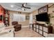 This living room features a ceiling fan and wood-look floors at 1087 Leisure World --, Mesa, AZ 85206