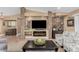 Stylish living room with stone fireplace, modern furniture, and neutral decor, creating a cozy, elegant space at 1087 Leisure World --, Mesa, AZ 85206