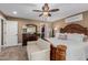 The primary bedroom has wood-look floors, a ceiling fan, and a walk-in closet at 1087 Leisure World --, Mesa, AZ 85206