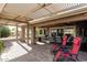 Covered outdoor patio featuring a stone floor, ceiling fans, and comfortable seating, great for entertaining at 1087 Leisure World --, Mesa, AZ 85206