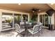 Covered patio with ceiling fan and elegant outdoor dining set, creating a relaxing outdoor space at 1087 Leisure World --, Mesa, AZ 85206