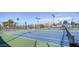 Well-maintained tennis courts with blue surface, surrounded by fencing, offering ample space for recreational play at 1087 Leisure World --, Mesa, AZ 85206