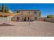 A spacious backyard features gravel landscaping and a shade sail, perfect for outdoor relaxation and enjoyment at 1120 E Jahns Dr, Casa Grande, AZ 85122