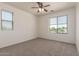 Spacious bedroom showcasing neutral walls, carpet and dual windows, providing ample sunlight at 1120 E Jahns Dr, Casa Grande, AZ 85122