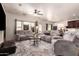 Comfortable living room featuring plush seating, a ceiling fan, and ample natural light, perfect for relaxation at 1120 E Jahns Dr, Casa Grande, AZ 85122