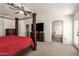 Serene main bedroom featuring a four-poster bed, ceiling fan, and an en-suite bathroom with a tub at 1120 E Jahns Dr, Casa Grande, AZ 85122