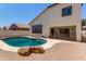 A private backyard oasis offers a refreshing pool, a covered patio, and a paved deck for relaxing at 15811 N 155Th Dr, Surprise, AZ 85374