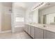 Bright bathroom with double sink vanity, soaking tub and a separate glass shower at 15811 N 155Th Dr, Surprise, AZ 85374