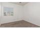 Carpeted bedroom featuring a bright window, neutral walls and ample space at 15811 N 155Th Dr, Surprise, AZ 85374