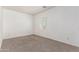 Empty bedroom features neutral carpet and walls, and a bright window at 15811 N 155Th Dr, Surprise, AZ 85374
