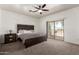 Cozy bedroom features plush carpeting, a sliding glass door, and neutral tones for a relaxing ambiance at 15811 N 155Th Dr, Surprise, AZ 85374
