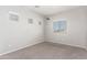 Bright bedroom with carpet, three windows, and neutral paint at 15811 N 155Th Dr, Surprise, AZ 85374