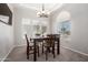 Well-lit dining room features a modern chandelier, large windows, and comfortable seating for Gathering dinners at 15811 N 155Th Dr, Surprise, AZ 85374