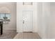 Front entry features a white door and tile flooring, and a view to the dining room at 15811 N 155Th Dr, Surprise, AZ 85374