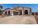 Charming single-story home features a well-manicured lawn, arched entryway, and a two-car garage at 15811 N 155Th Dr, Surprise, AZ 85374